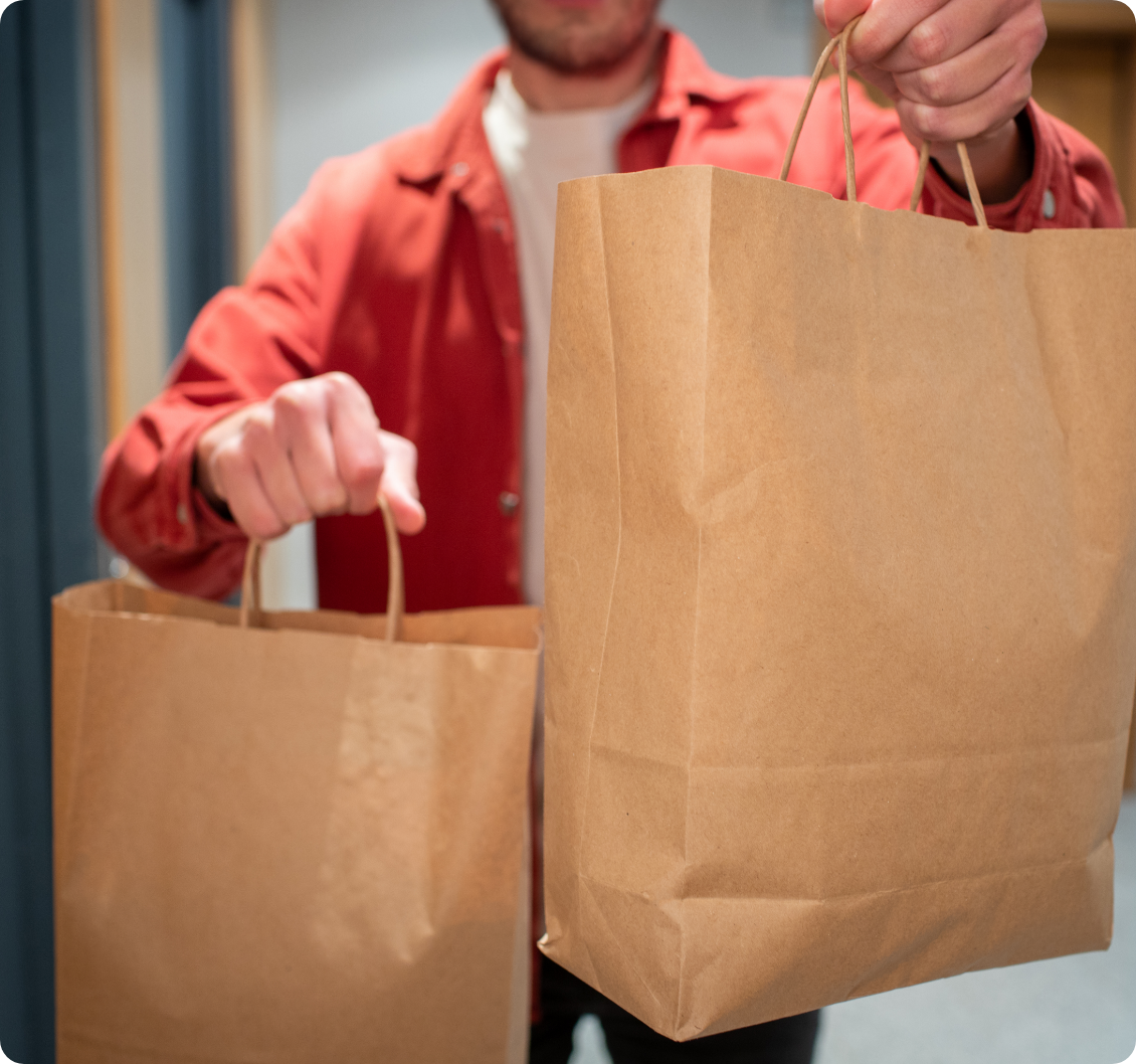 Delivery Man Holding Paper Bag with Food